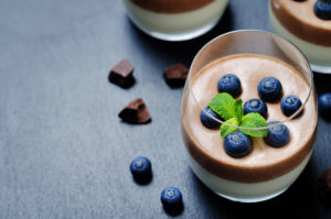 Chocolate treat with blueberries on top.