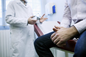 A man talks to their doctor about prostate cancer during their appointment.